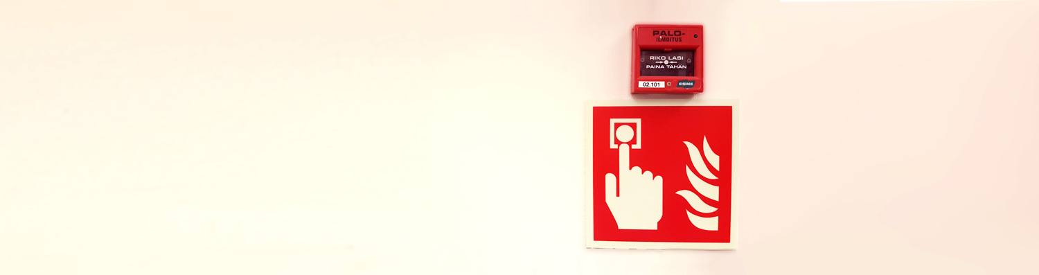 a fire alarm button and an instruction poster of how to operate the button