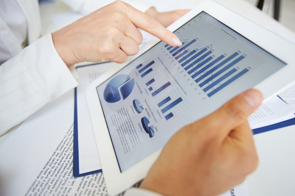 a work pair going through diagrams on a tablet